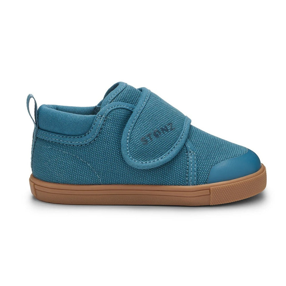 Stonz Cruiser Natural Toddler Shoes Denim, blue denim with Velcro closure fastened on a toddler's foot.