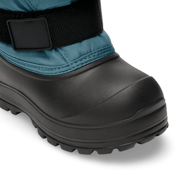 Stonz Trek Kid Snow Boots Denim, teal denim upper with black rubber toe and rugged sole; strap closure visible.