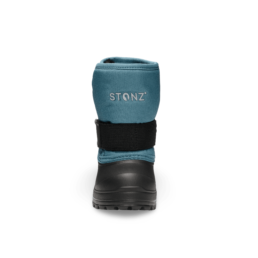 Stonz Trek Toddler Snow Boots Denim in teal with a black rugged sole and adjustable strap, shown from the rear.