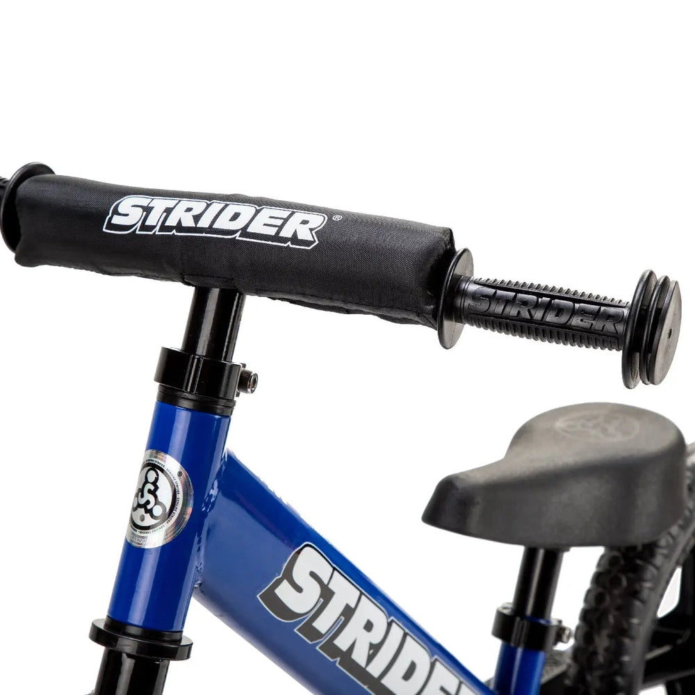 STRIDER Strider 12 Sport balance bike with blue frame and black padded handlebars gripped for riding