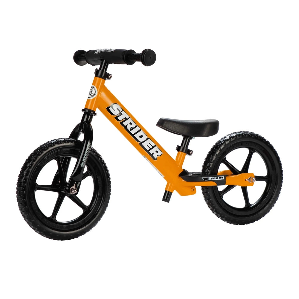 Strider 12 Sport Balance Bike, orange frame with black wheels and padded handlebars for toddlers.