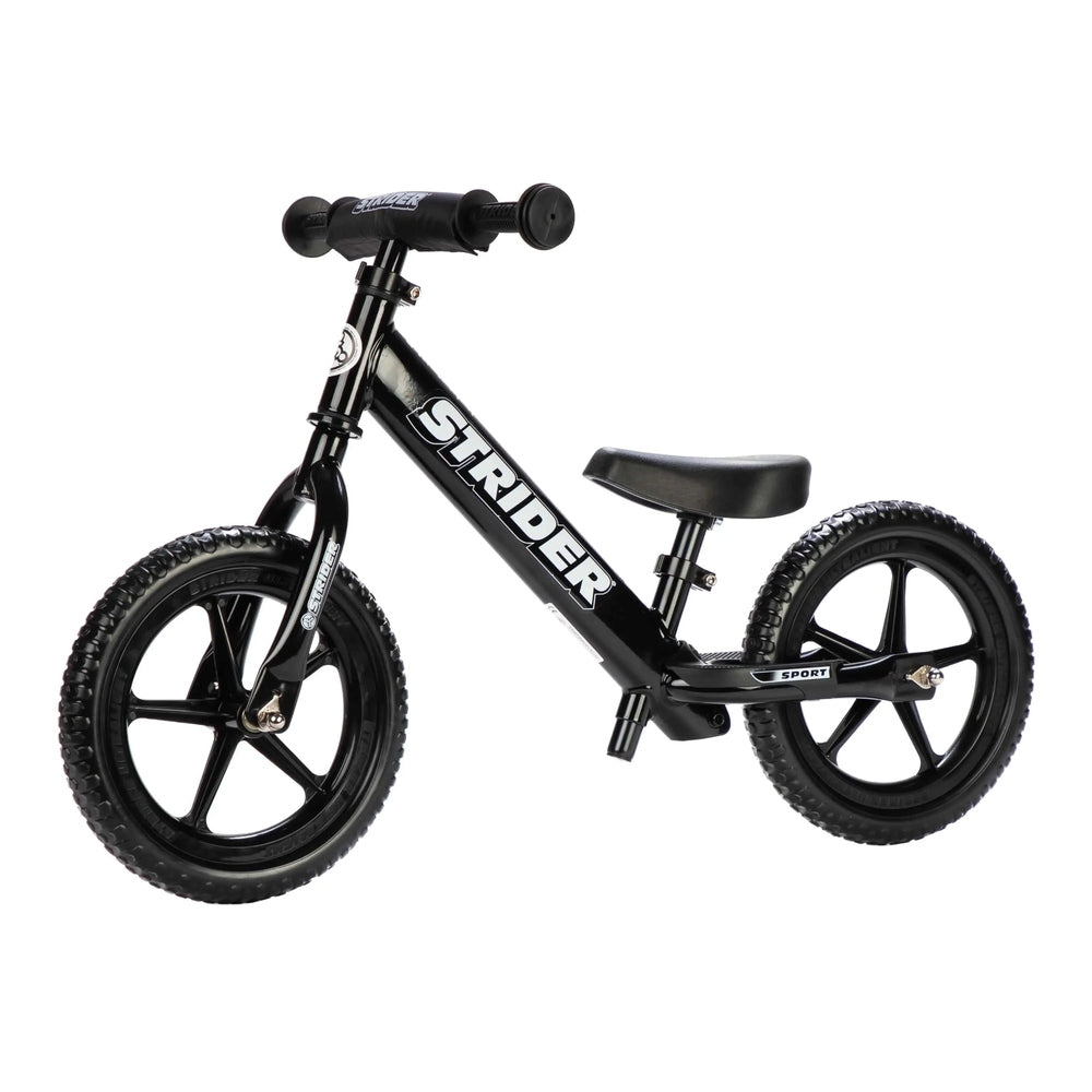 Strider 12 Sport Balance Bike in black with knobby tires, pedal-free design helps kids balance.