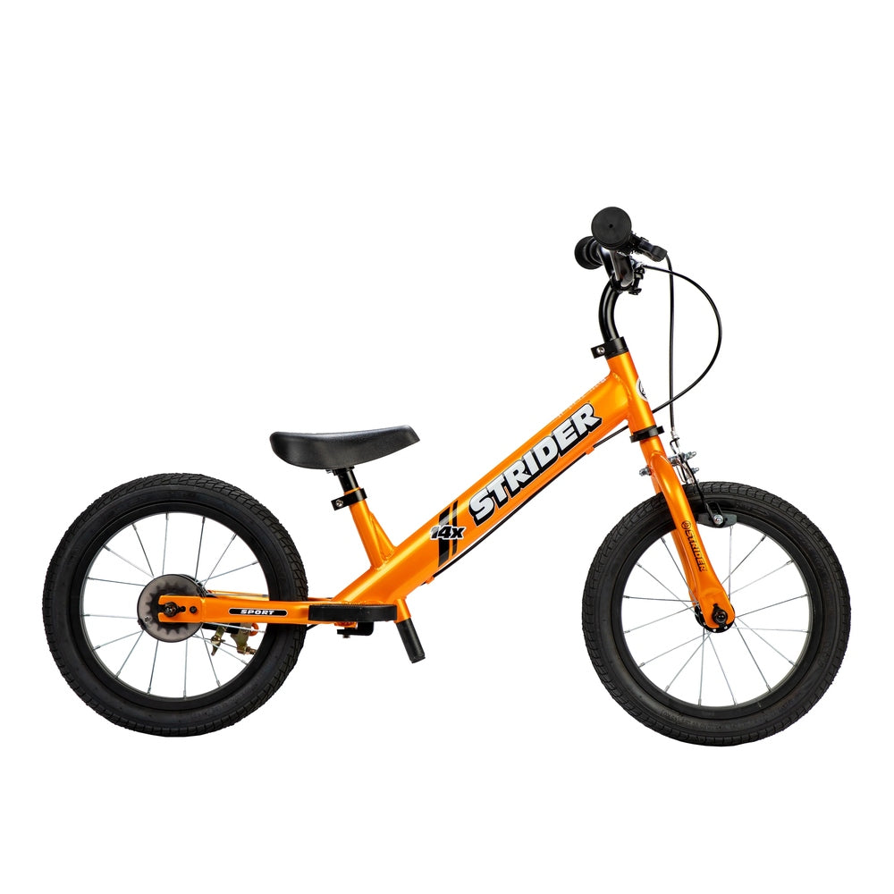Strider 14X Sport balance bike, bright orange frame with black saddle and 14x wheels, poised for ride.