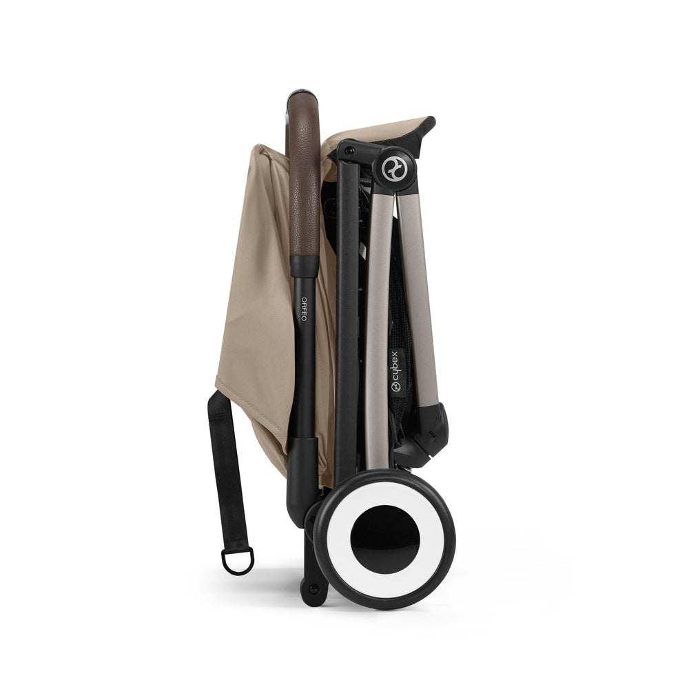Studio product image of the Cybex Orfeo Compact Lightweight Travel Stroller folded in beige, side view on white background.