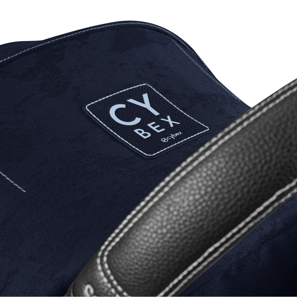 Studio product image of the Cybex Platinum Mios 3 Stroller Rebellious Luxury Denim Blue Denim-blue Cybex MIOS 3 stroller seat with leather-look grey handle and Cybex badge patch on white background.
