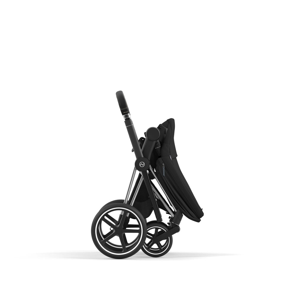 Studio product image of the Cybex Platinum Priam 4 Luxury Stroller One Box Pack in Sepia Black with Chrome Black frame, folded side view on white background.