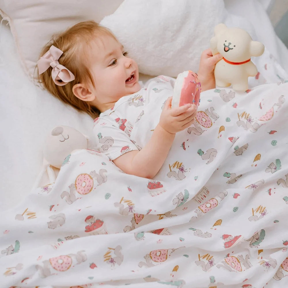 NEST DESIGNS Nest Designs Swaddle Blankie Very Squirrelly illustrated squirrels with donuts in scattered pattern img 2/6