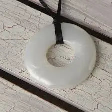 Teethease Original Pendant white silicone teether hanging on a black cord necklace
