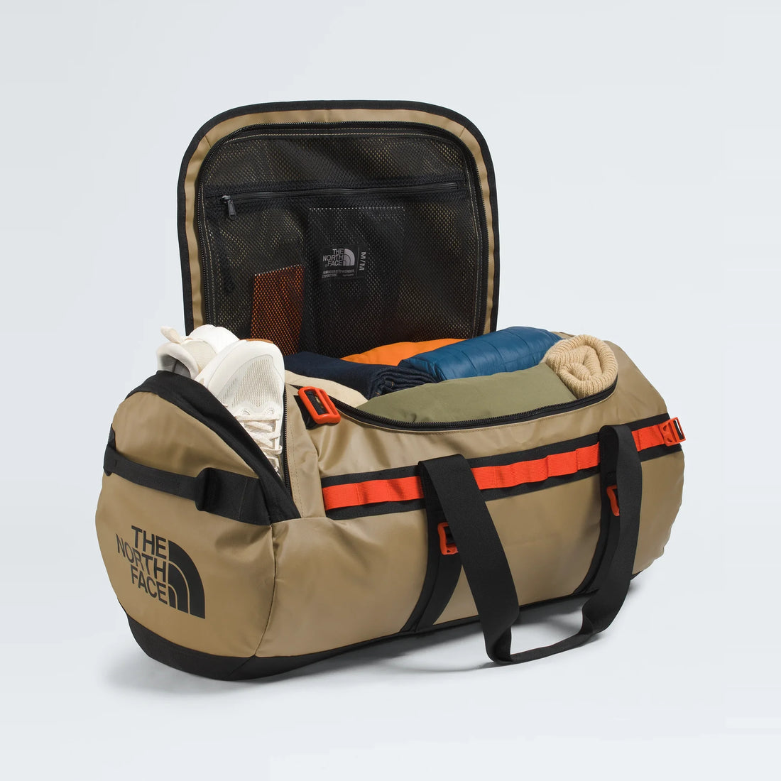 The North Face Base Camp Duffel - M - Cedar/TNF Black/Lava Red - open main compartment with example contents