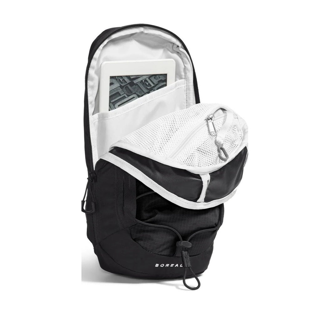 The North Face Borealis Sling Backpack in Black with white mesh pocket and tablet in main pocket