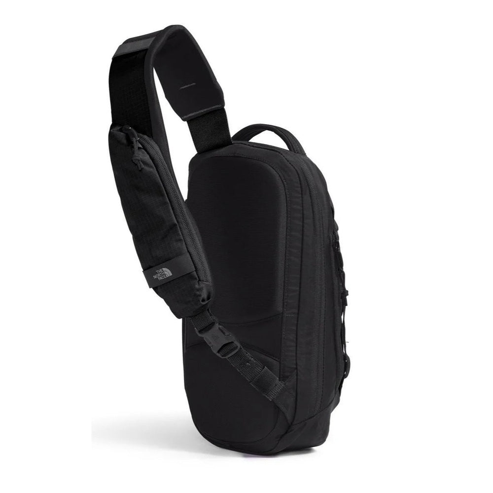 The North Face Borealis Sling Sling Bag in Black, side view.