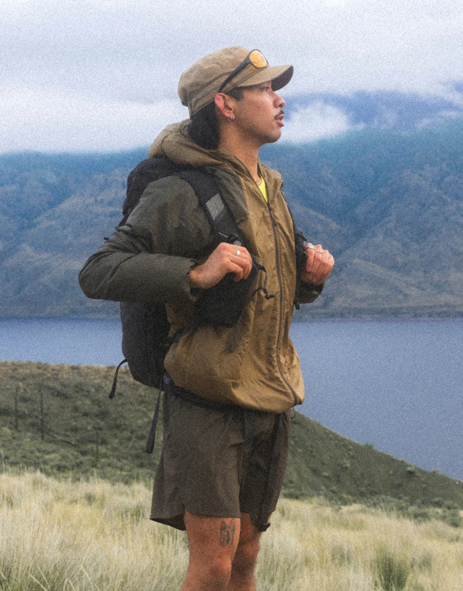 The North Face Ridgelite wind jacket, hiker wearing the jacket on an exposed trail