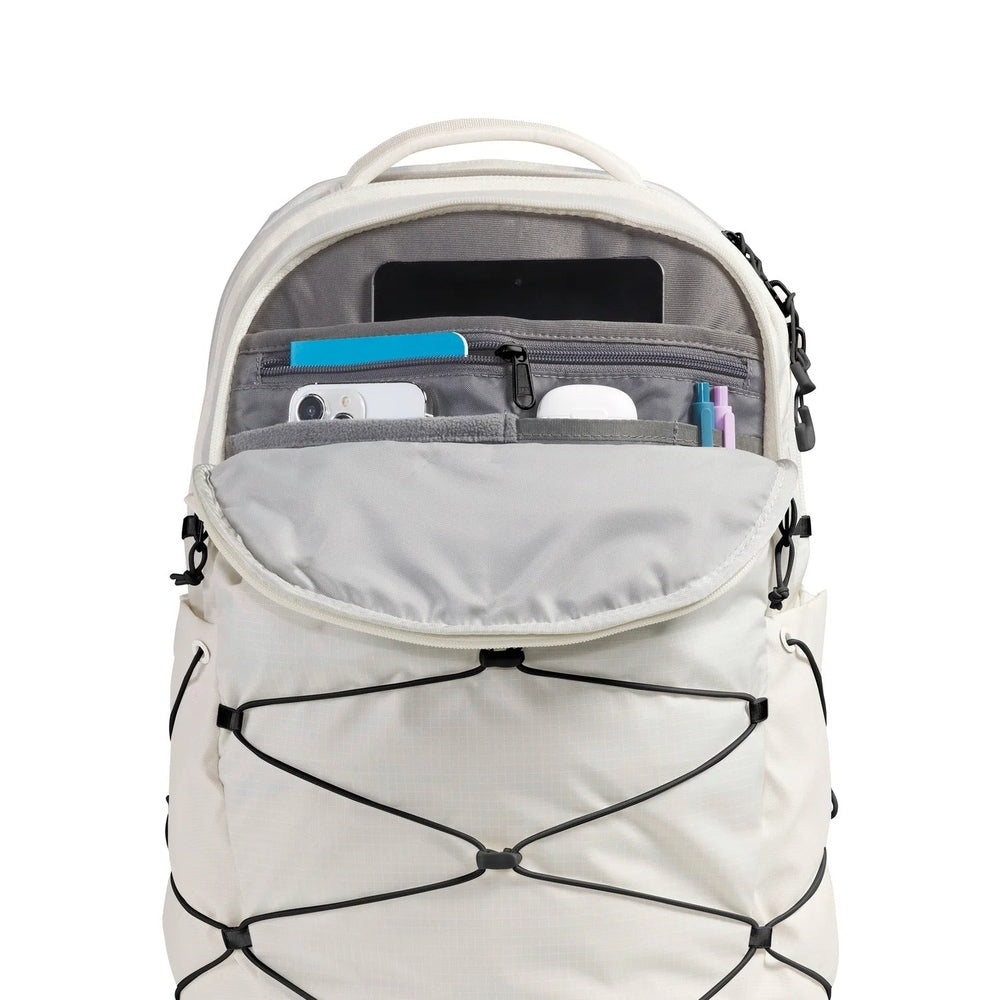 The North Face Borealis Backpack in Cream with grey interior, open front pocket and elastic bungee cords.