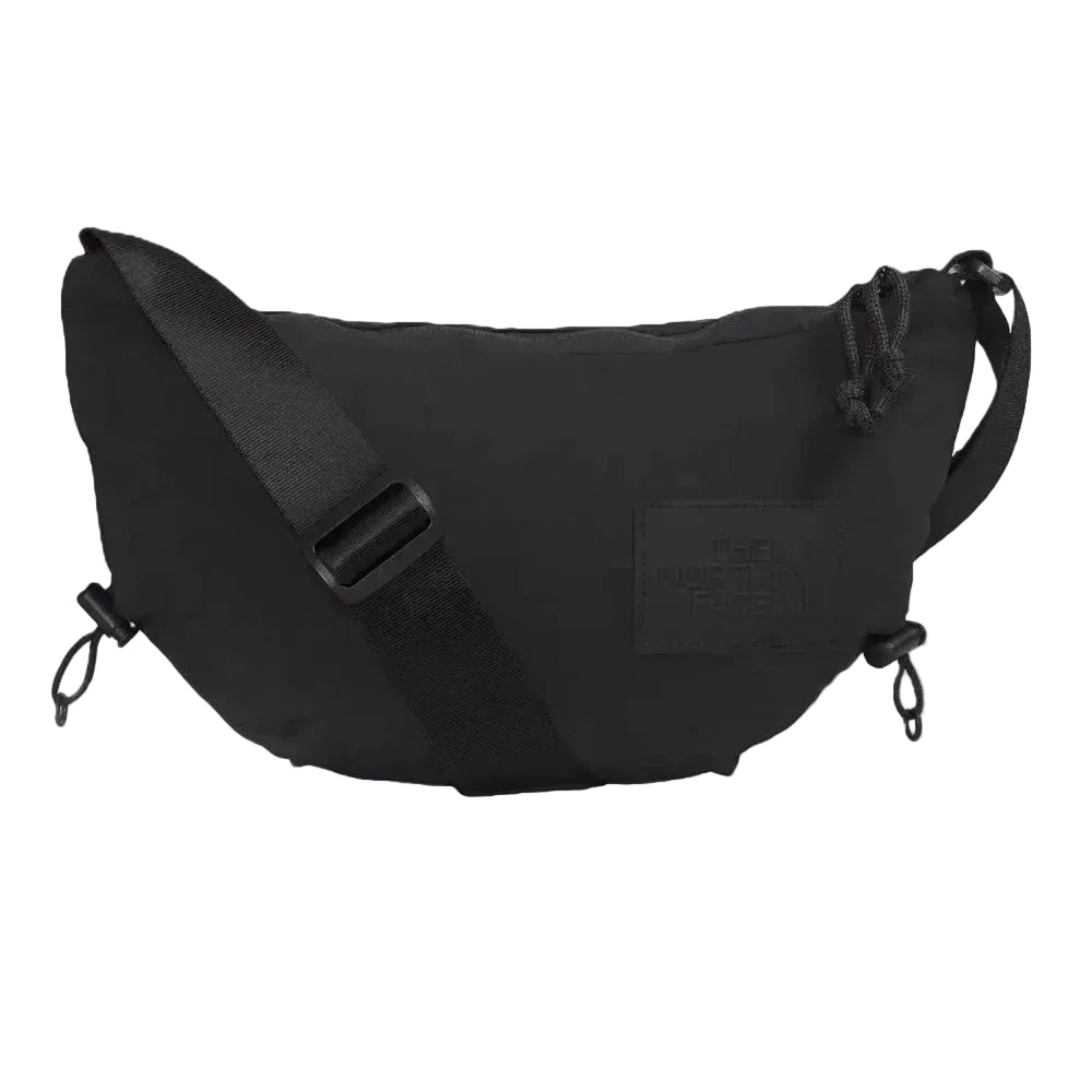 The North Face Never Stop Crossbody Bag in Black with adjustable strap and front logo patch.