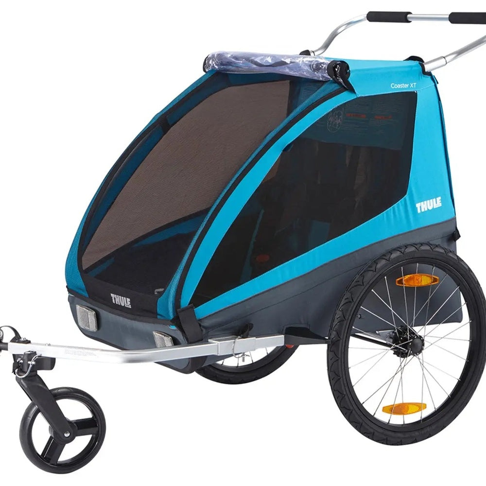 Thule Coaster XT bike trailer stroller in blue with mesh panels and silver frame, ready to tow behind a bicycle.