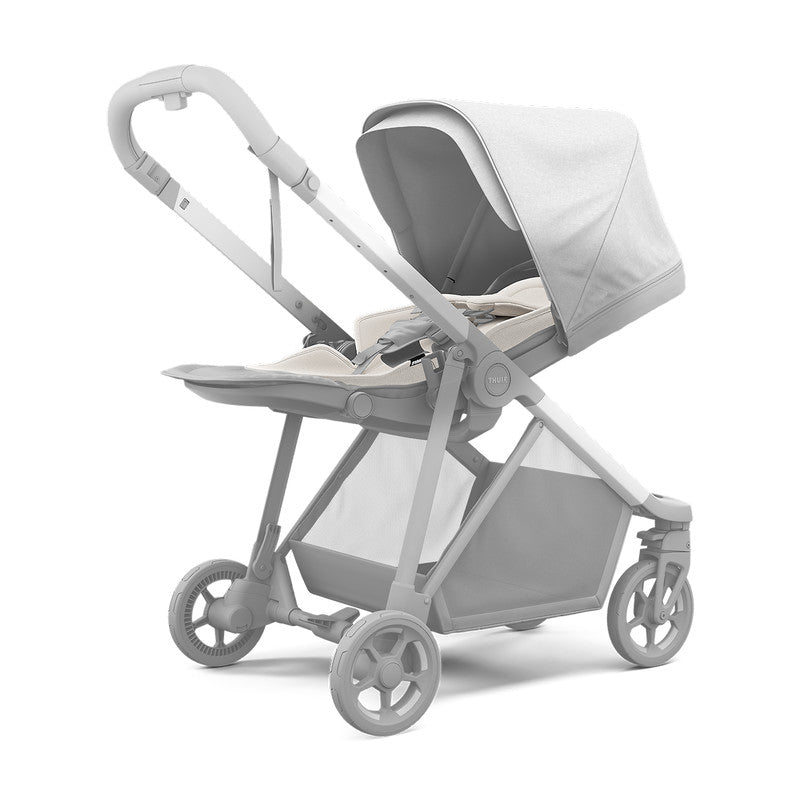 Thule Newborn Inlay Gray stroller accessory installed on a gray stroller with canopy