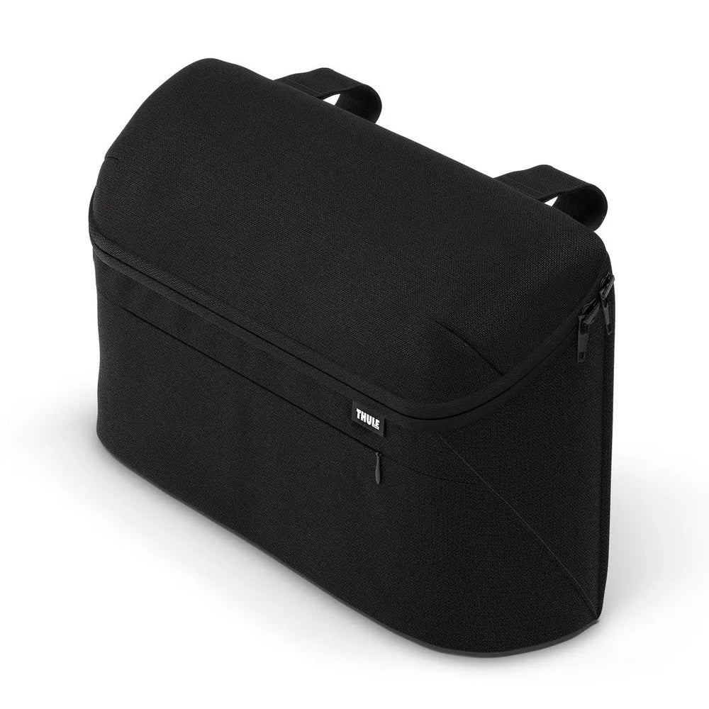 Thule Organizer black travel toiletry bag, top handle visible, zipper closure shown with pull tab.
