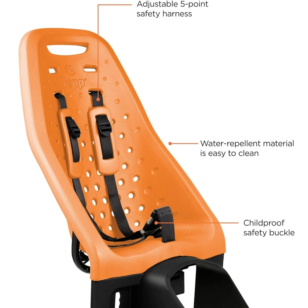Thule Yepp Maxi rack-mounted child bike seat in orange with buckled 5-point harness