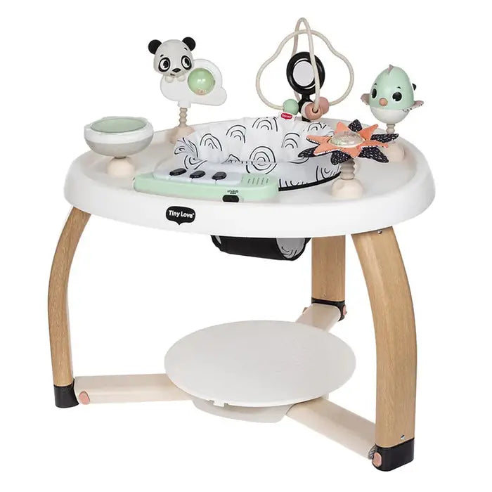 Tiny Love 5-In-1 Here I Grow Stationary Activity Center with white padded top, wooden legs, and hanging panda/bird toys.