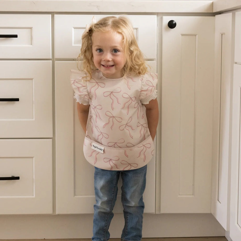 TINY TWINKLE Tiny Twinkle Mess-Proof Apron Bib 6-24M Ruffled sleeves with front pocket and ribbon bow print img 6/15