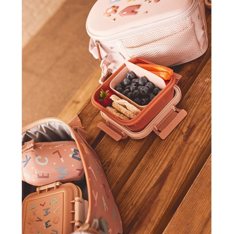 Tutete Kids Large Lunch Box with pink exterior and divided compartments, blueberries and crackers