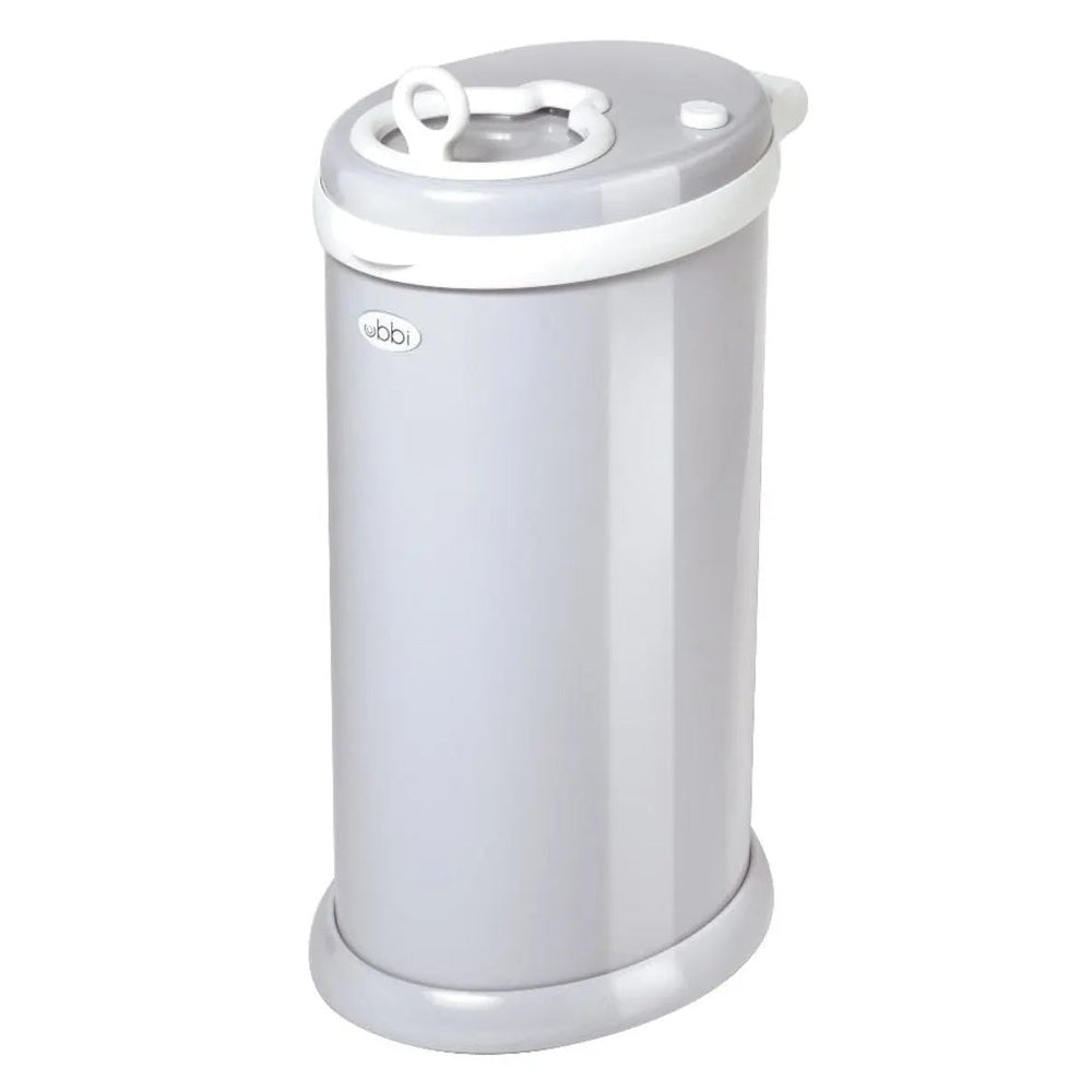Ubbi Diaper Pail in light gray with white lid; ring-style top for easy loading.