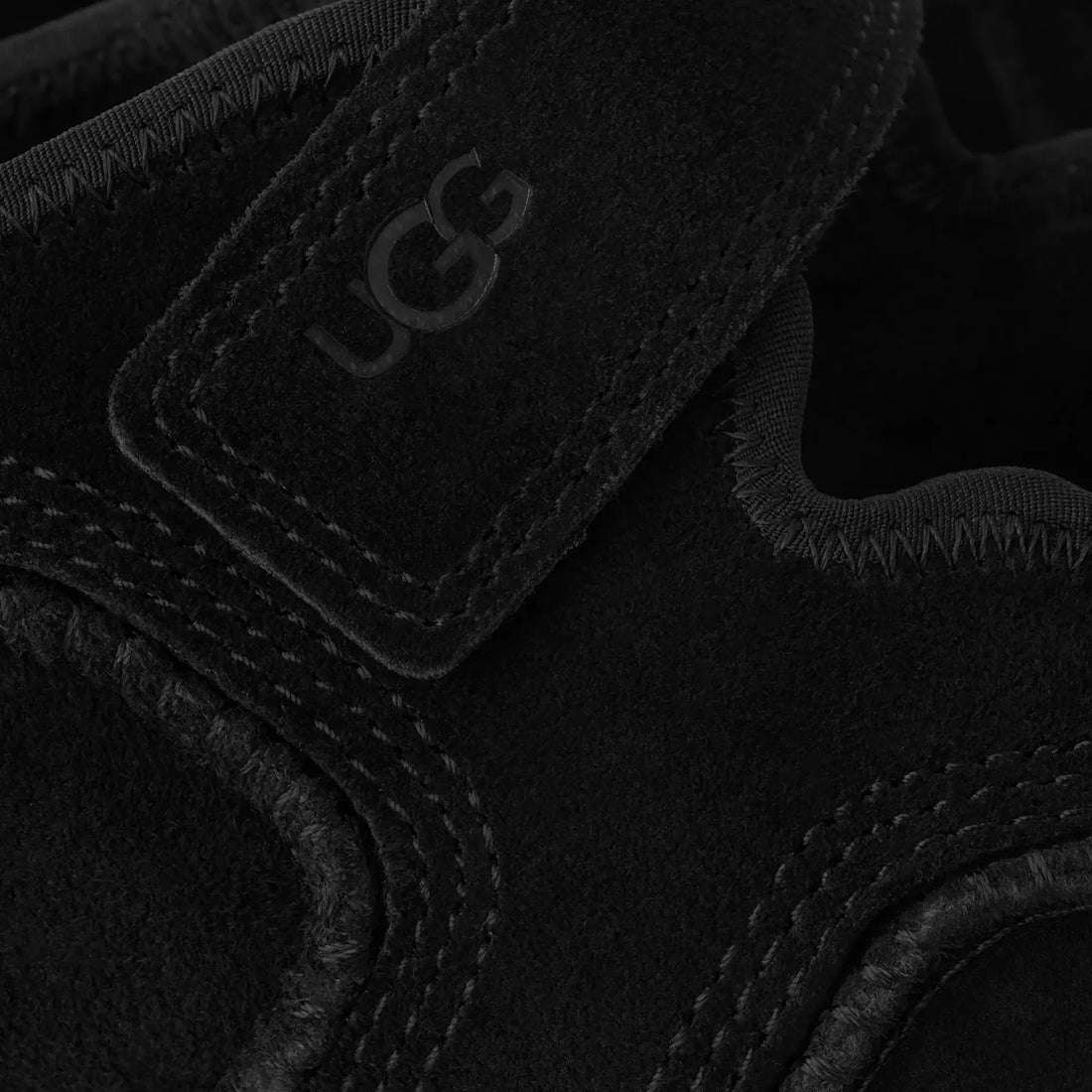 UGG Quill Mary Jane in Black, close-up of suede strap and embossed logo