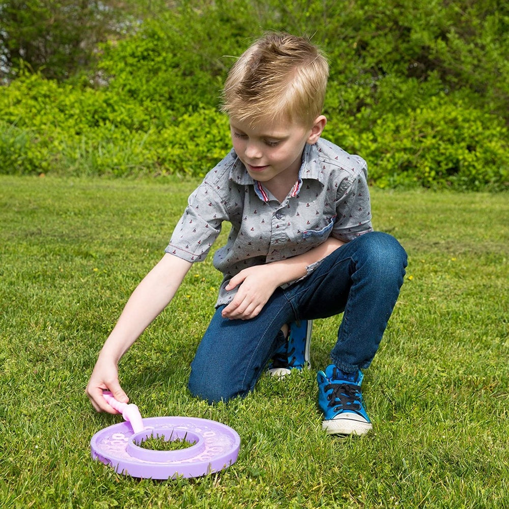 Uncle Bubble Fun Fantasy Wand 4 oz bubble toy; purple wand and disc, child playing outdoors.