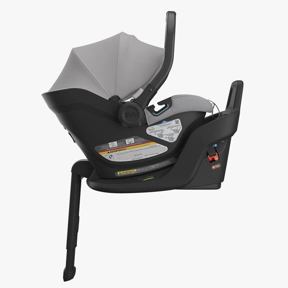 UPPAbaby Aria infant car seat installed on base, shown from the side with gray canopy extended and load leg deployed.