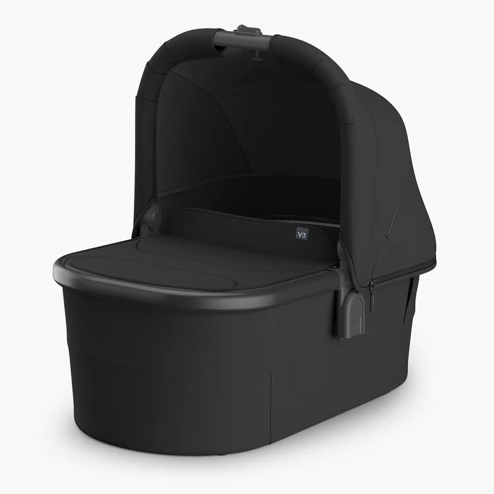 Uppababy Bassinet V3 in black fabric with curved canopy surrounding an open bassinet base