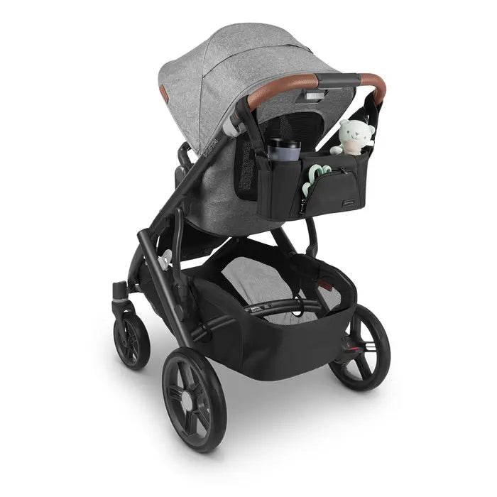 Black carry-all parent organizer with pockets and cup holder on a grey stroller