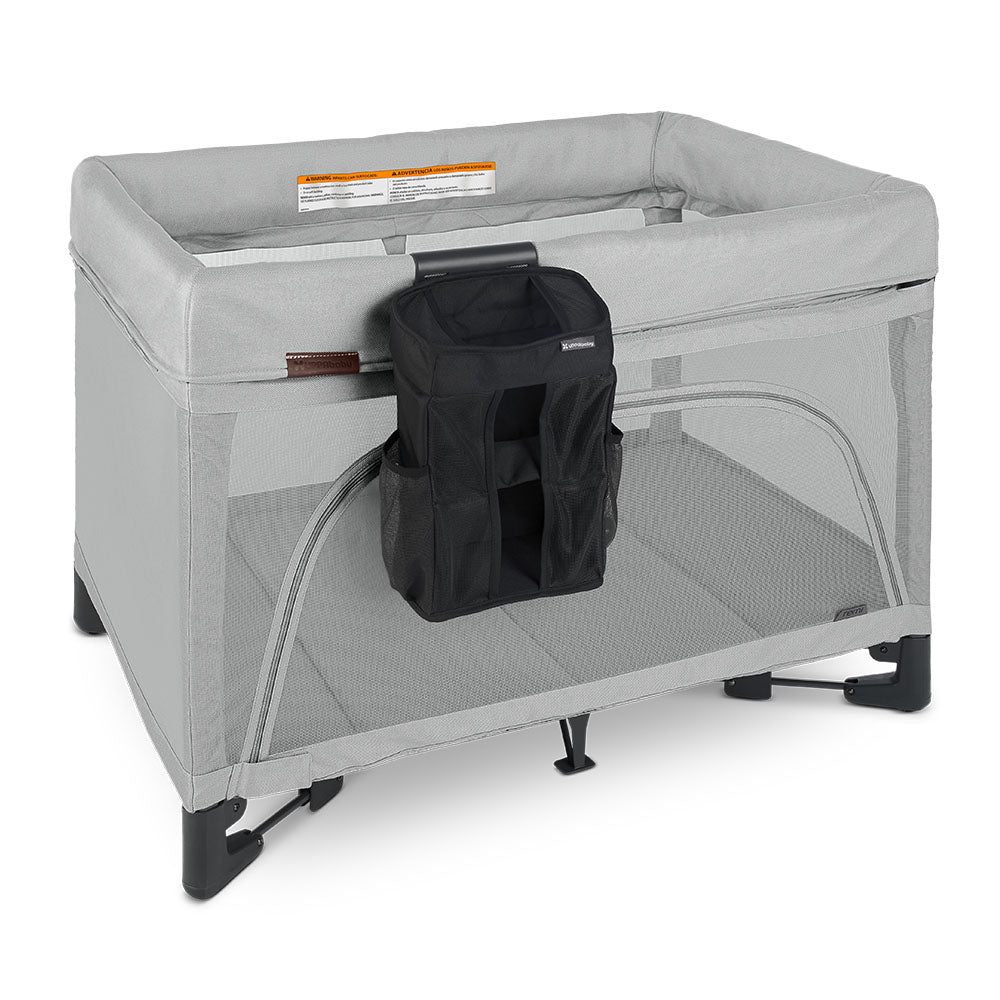 Uppababy changing station organizer for Remi, attached to a grey bassinet playard with black storage pouch