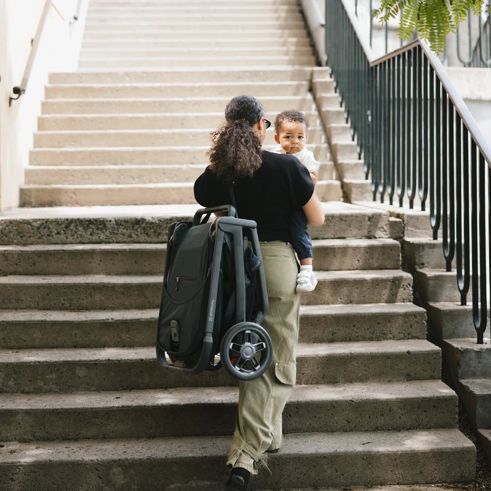 UPPAbaby Kona in James folded on outdoor stairs