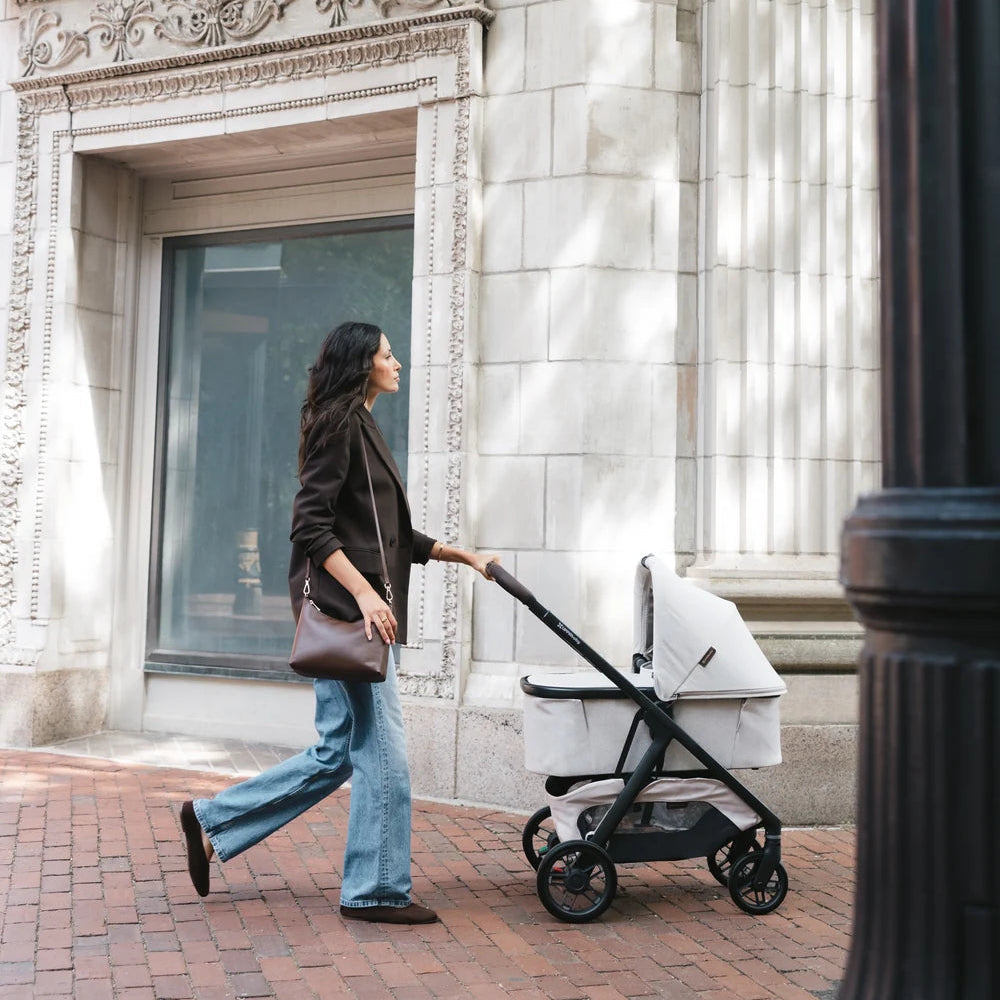 UPPAbaby Kona with an optional bassinet on a city walk