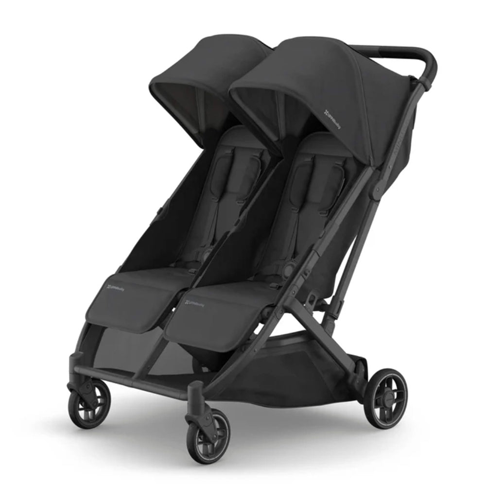 Uppababy Minu Duo Stroller in black with twin seats and canopies, front wheels turned for easy maneuvering