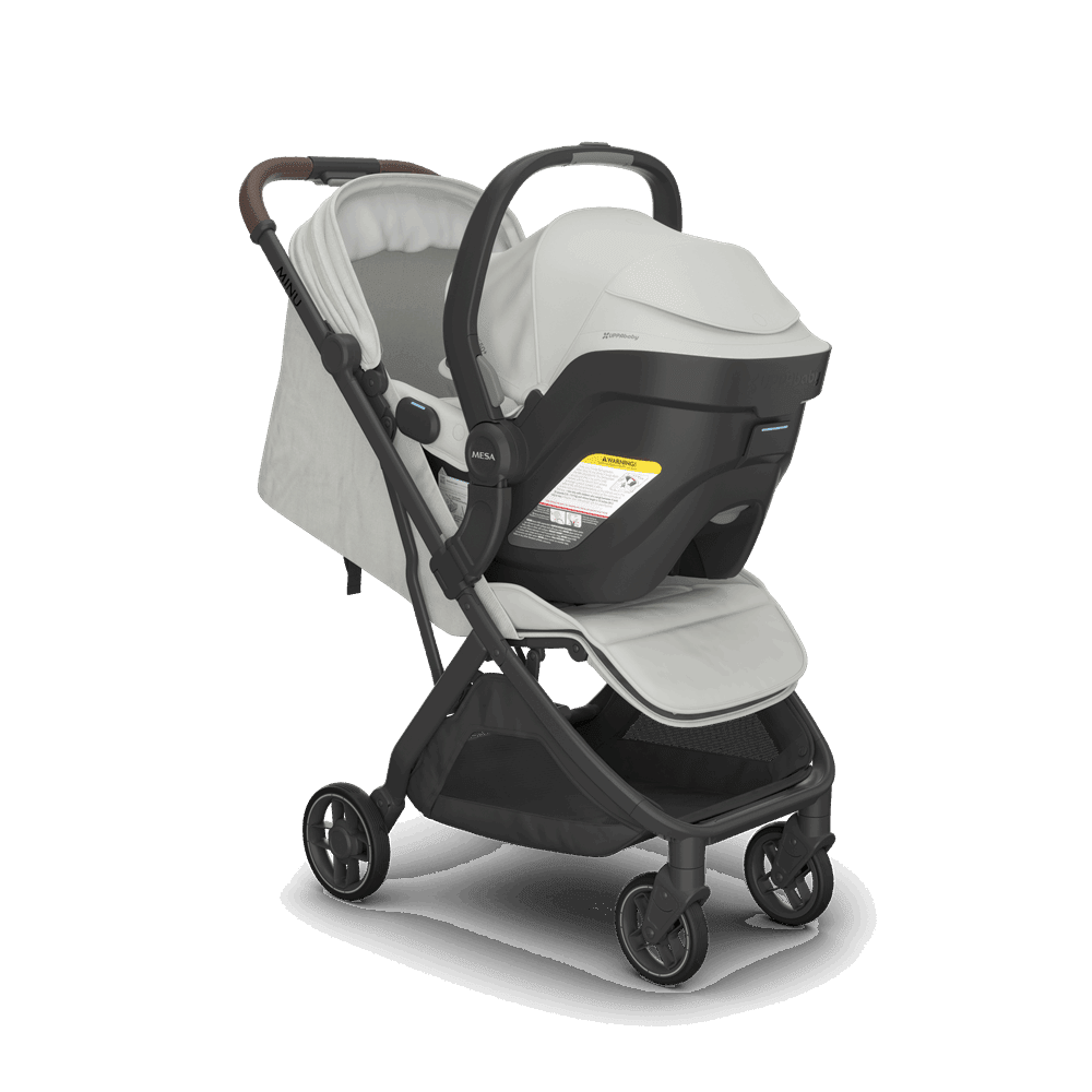 Uppababy Minu V3 stroller with cream bassinet-style seat on black frame