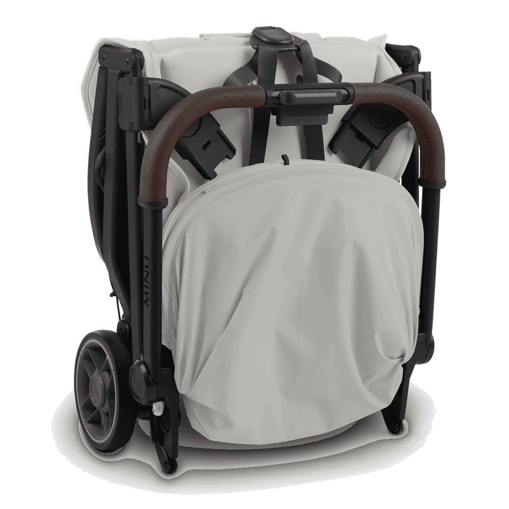 Uppababy Minu V3 stroller folded in beige fabric with brown leatherette grip handle and compact design