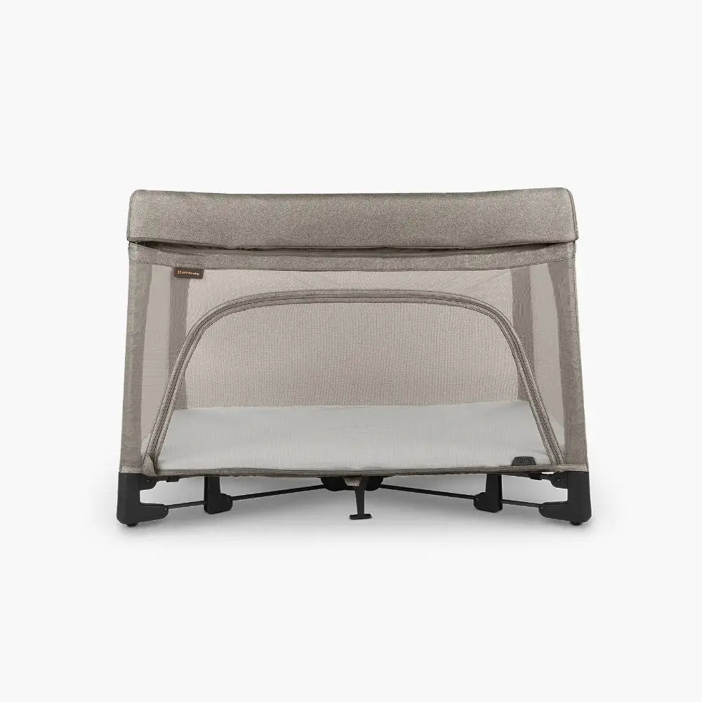 Uppababy Remi Playard in beige mesh with white mattress, showing breathable mesh sides and sturdy dark frame.
