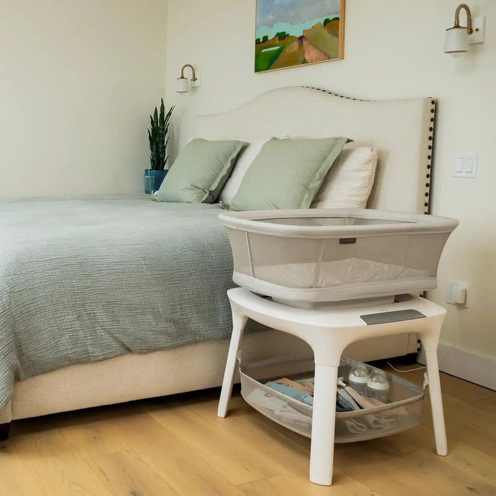 Uppababy Soma Smart Bassinet in Cream with mesh sides on white stand
