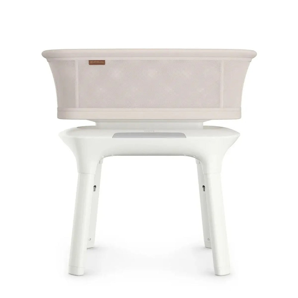 UPPAbaby Soma Smart Bassinet in Soft Beige with mesh sides on white stand