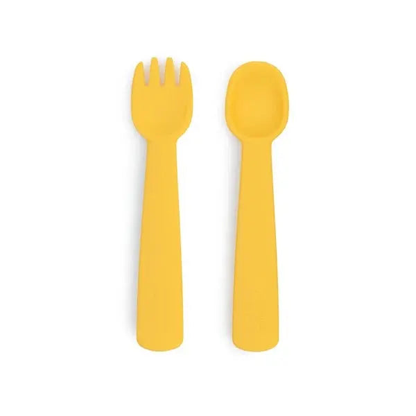 We Might Be Tiny Feedie Fork & Spoon Set: two yellow silicone feeding utensils shown side by side for babies ready to eat