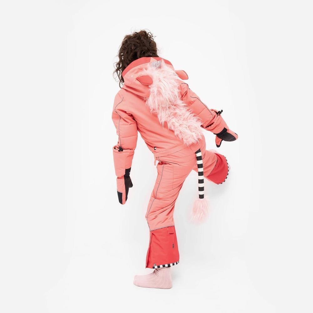 Weedo Silver Unido Unicorn Snowsuit for toddlers in pink with fluffy tail, shown kneeling in playful insulated outerwear.
