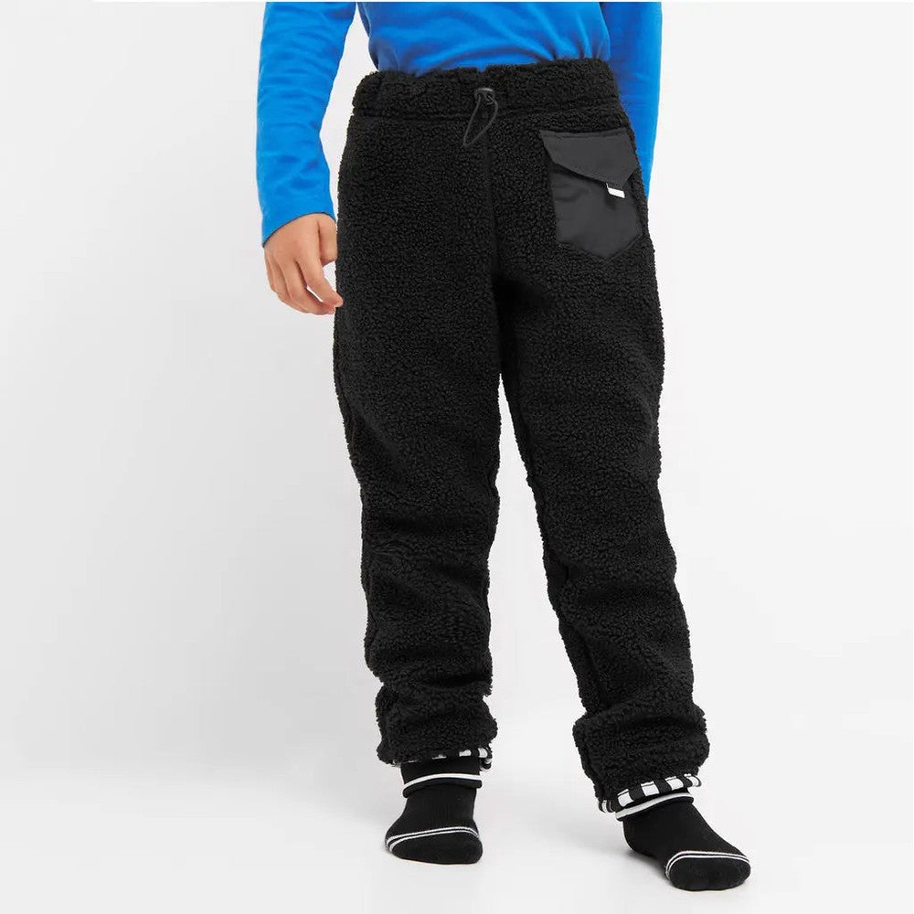 Weedo Teddy Fleece Pants; black sherpa joggers with drawstring waist and front pocket, worn by a standing toddler.