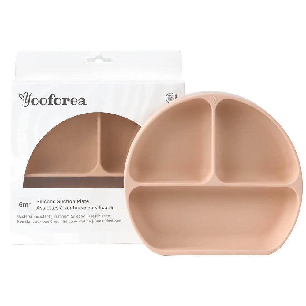 Yooforea Silicone Suction Plate in peach silicone with 3 compartments, firmly clinging to a table.