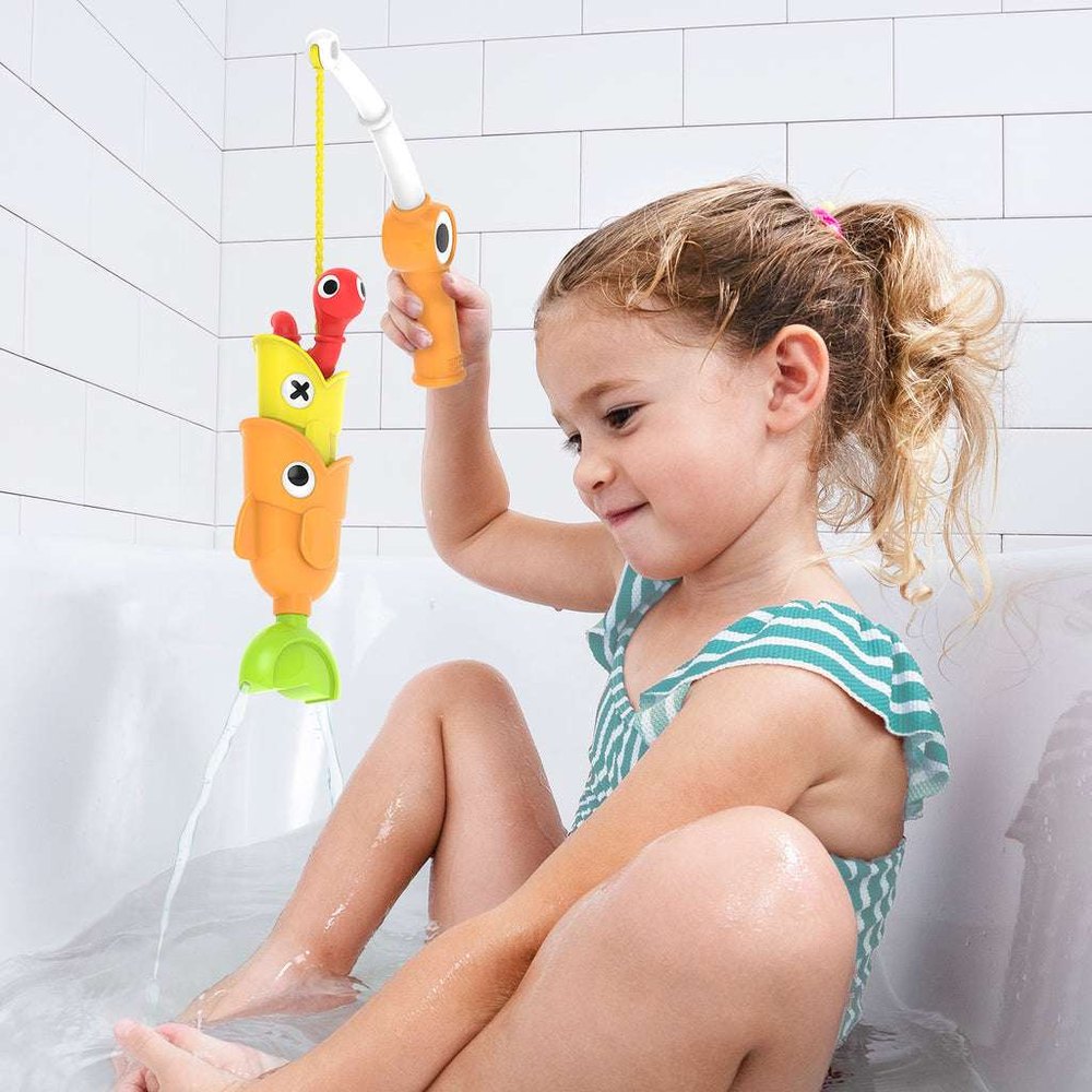 Yookidoo Catch N Sprinkle Bath Fishing Set with bright orange/yellow fish toys and a child playing