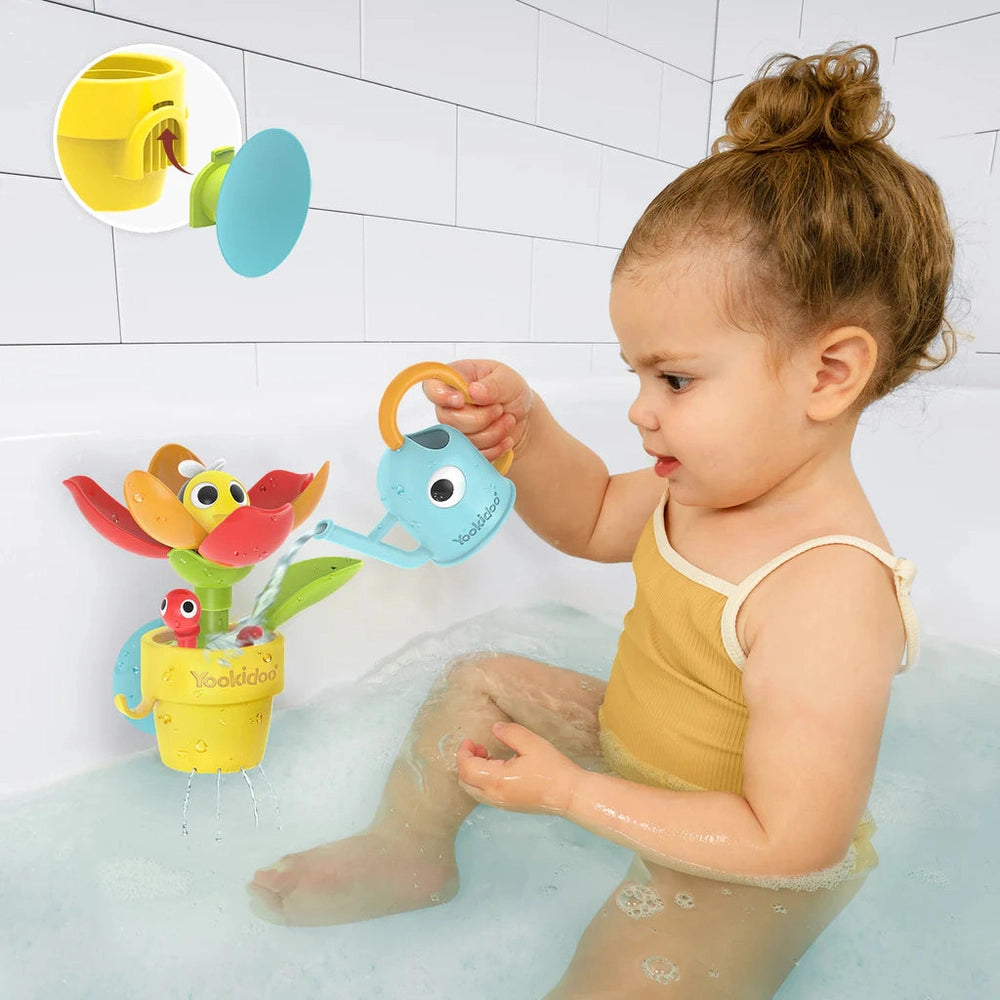 Yookidoo Peek-A-Bee Flower Tub bath toy; bright yellow flower fountain waters the tub as a toddler plays with the bee sprayer.