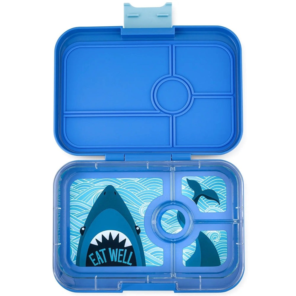 Yumbox Tapas 4-Compartment Lunchbox in blue, open to reveal wave-pattern interior and Eat Well shark graphic.