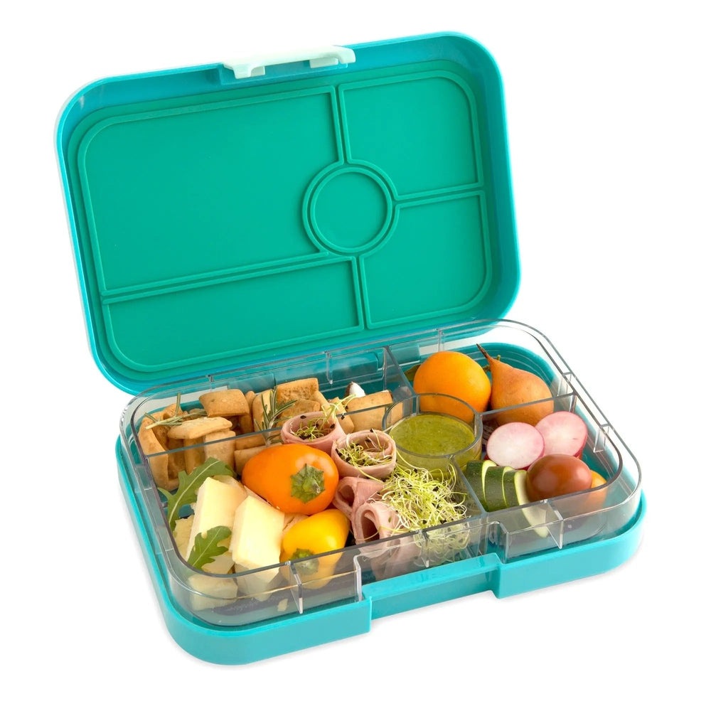 Yumbox Tapas 5 Compartment Lunchbox in teal lid, clear tray with five compartments filled with assorted snacks.